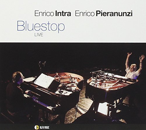 "Album cover with two musicians on stage, one at piano, the other at drums."