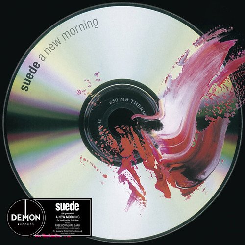 CD with pink paint splatter design and "Suede A New Morning" text on a black background.