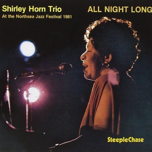 "Jazz album cover featuring a woman singing into a microphone under stage lights."