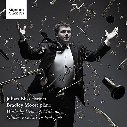 CD cover featuring clarinetist Julian Bliss amidst falling brass instruments.