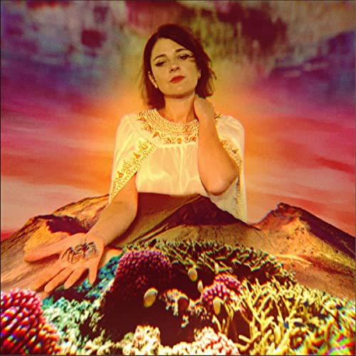 Woman with hands on a colorful, textured landscape; album cover.