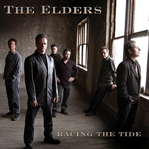 "Album cover featuring five men in dark attire standing in a dimly lit room."