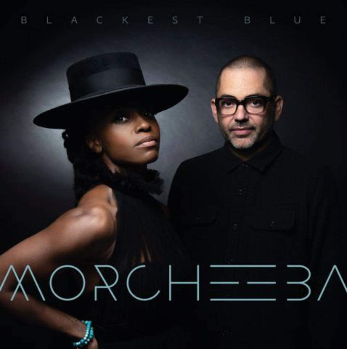Morcheeba album cover featuring a woman in a hat and a man in black clothing.
