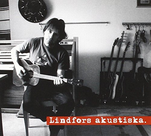 Black and white photo of Staffan Lindfors playing acoustic guitar.