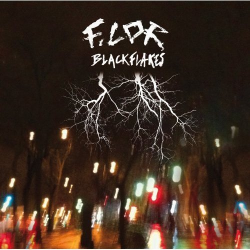 "Album cover with 'F.LOR' and 'BLACKFLAKES' text, white branches, and a dark cityscape background."