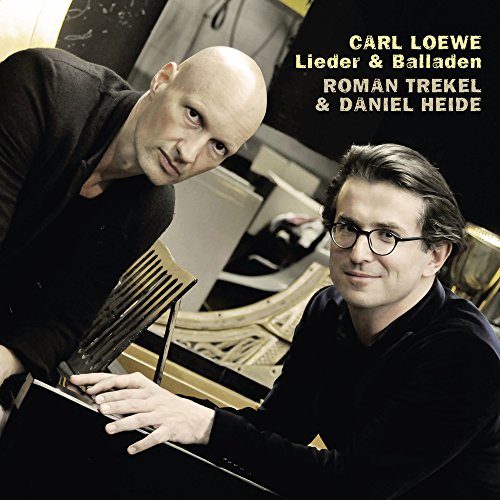 "CD cover featuring two men, one playing piano, against a black background with yellow text."