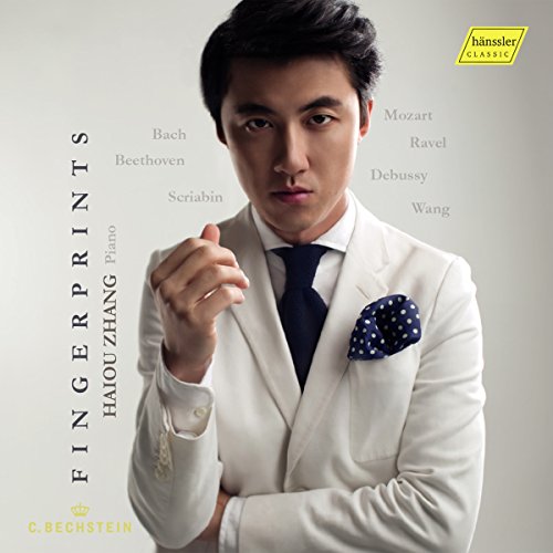 Man in white suit and blue tie on a CD cover.