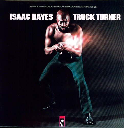 Vinyl album cover featuring a shirtless man holding handcuffs, with bold white text.