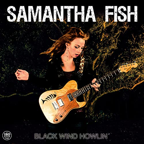 Samantha Fish album cover: woman with guitar against a dark, textured background.