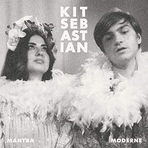 Black and white vinyl album cover featuring a man and woman in feathered attire.