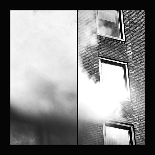 Album cover with a black-and-white image of smoke billowing from a brick building.