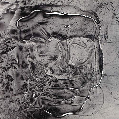 The alt text for the image is: "A crumpled silver CD with a distorted, abstract reflection."