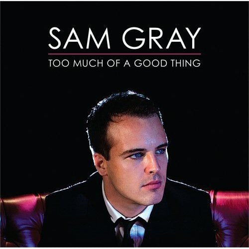 "Album cover featuring a man in a suit against a black background."
