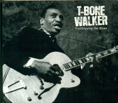 Black and white photo of T-Bone Walker playing an electric guitar.