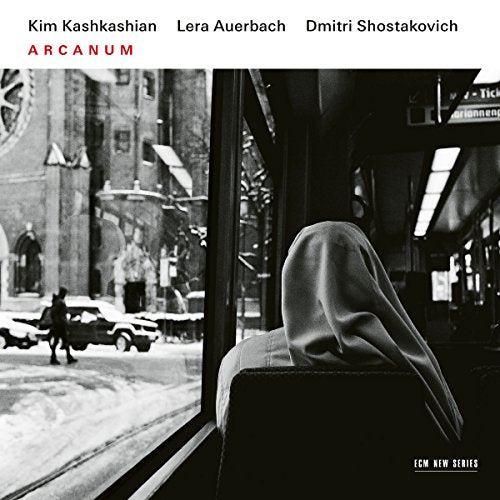A black and white CD cover featuring a shrouded figure on a bus.