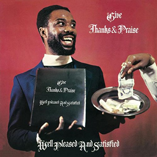 Man in suit holding a book and offering plate with money.