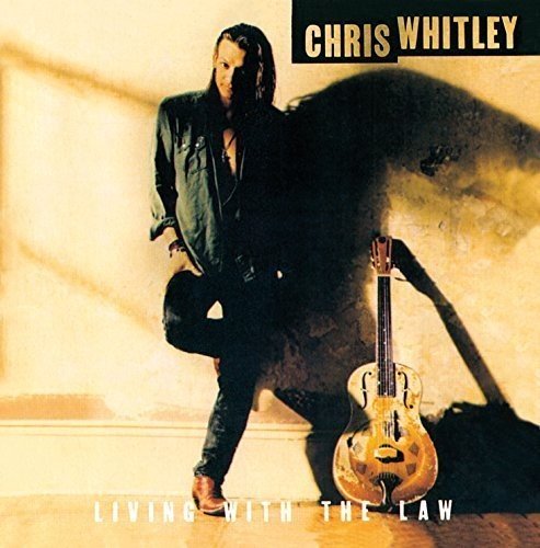 Chris Whitley's album cover: man in black leaning on a guitar, shadowy background.