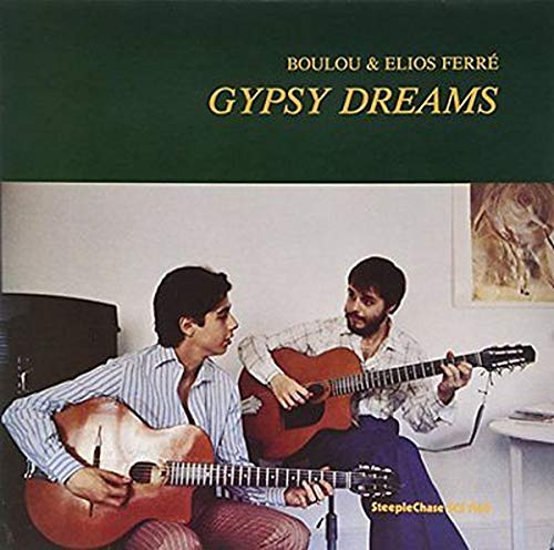 Album cover: two men playing acoustic guitars indoors.