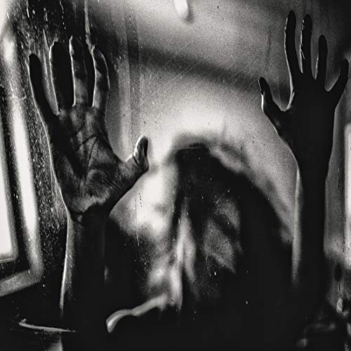 Black and white image of hands pressed against a glass surface with blurred features.