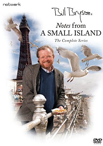 Bill Bryson stands by a railing with seagulls, the Blackpool Tower in the background.