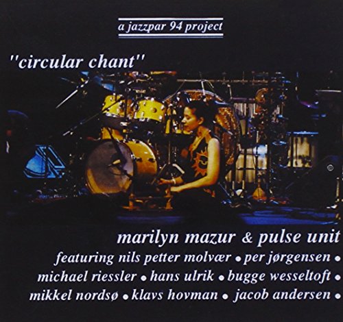 Drummer Marilyn Mazur performing surrounded by a complex drum kit.