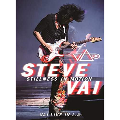 Steve Vai playing an electric guitar on stage with text overlay of album title.
