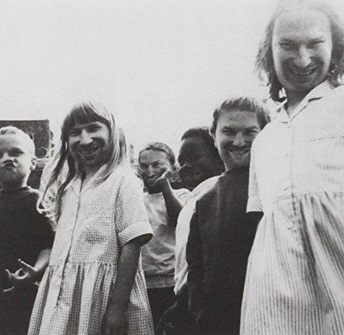 Black and white photo of several people with the same man's face superimposed.