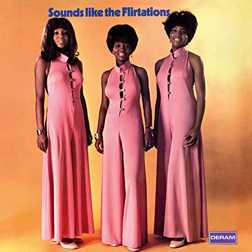 Album cover for "Sounds Like The Flirtations" featuring three women in pink jumpsuits.