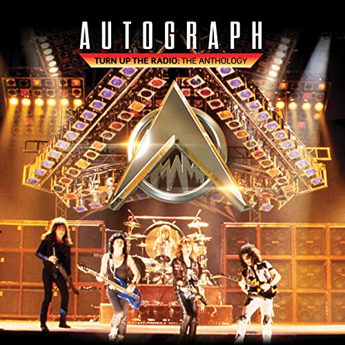 Autograph album cover featuring a band performing on stage with lights.