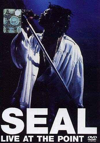Seal performing live on stage, wearing white, with DVD branding.