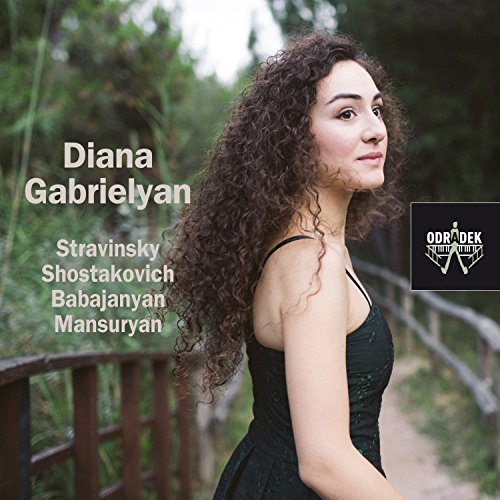 "CD cover featuring a woman in a black dress on a wooden bridge."