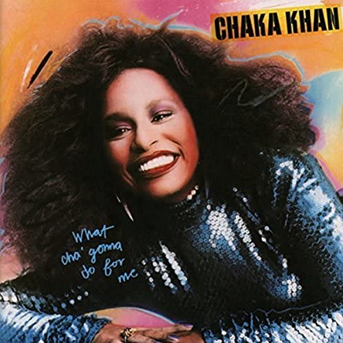 Chaka Khan album cover, smiling with large afro and sparkling blue top.