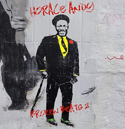 "Album cover featuring a man in a suit on a graffiti wall."