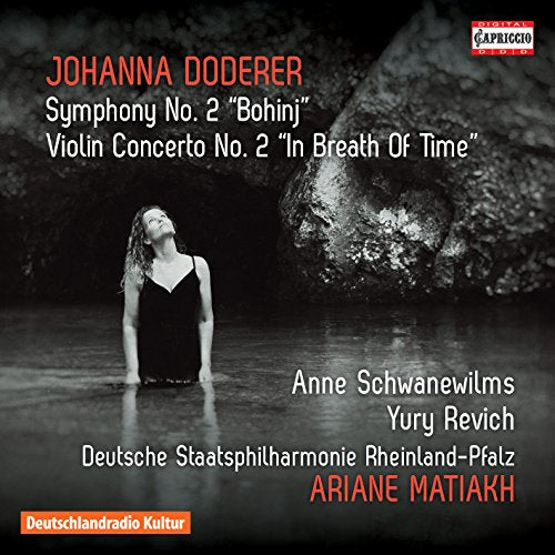 CD cover featuring a woman in a black dress standing in a dark, reflective space.