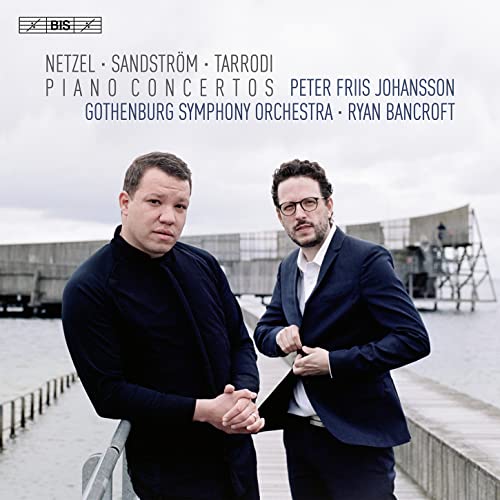 Album cover featuring two men in dark suits standing by a waterfront pier.