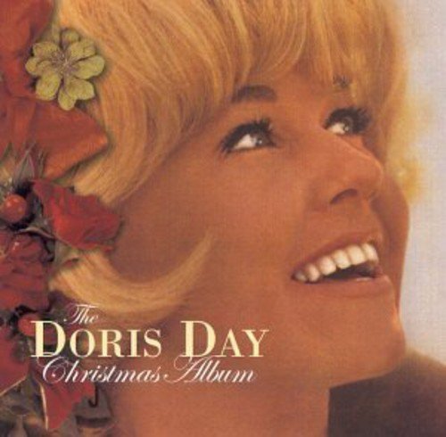 Doris Day's smiling face on a Christmas album cover with flowers in her hair.