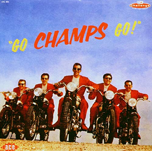 Five men in red jackets riding motorcycles against a blue sky.