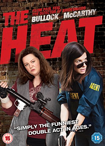DVD cover for "The Heat" featuring two women holding guns against a brick wall.