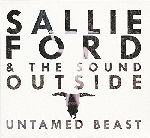 Album cover with a woman hanging upside down, surrounded by text on a white background.