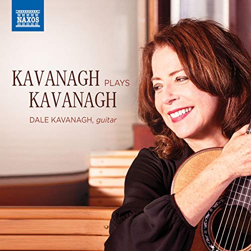 Woman with red hair holding a guitar, smiling, on a music CD cover.