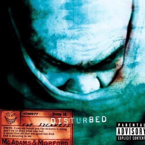 A close-up of a mouth with the Disturbed album cover artwork and parental advisory label.