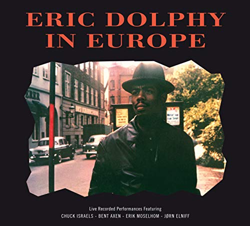 Album cover with a man in a hat on a city street.