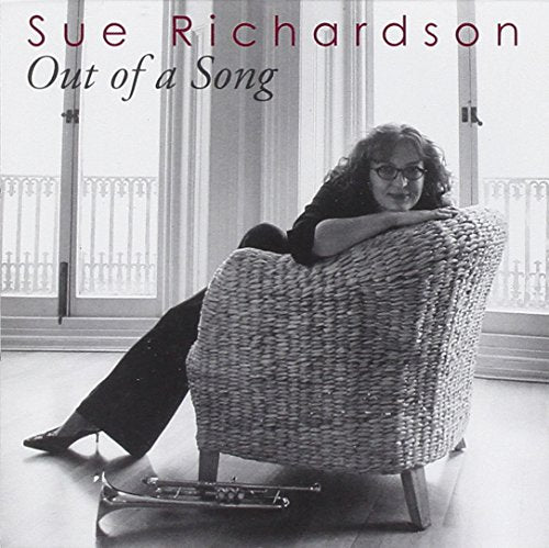 "Album cover with a black and white photo of a woman sitting in a wicker chair."