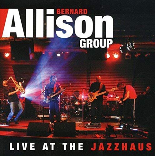 Bernard Allison Group performing live on stage under red stage lights.