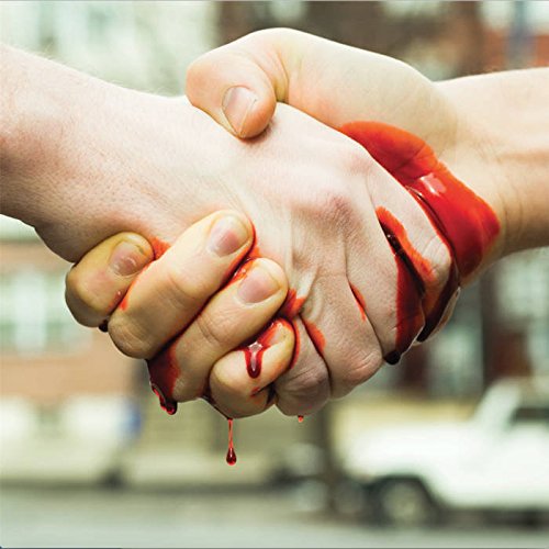 Two hands clasped together, covered in blood, against a blurred city background.