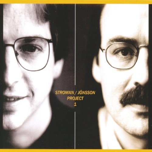 "CD cover with two men's faces, one with moustache, yellow text and borders."