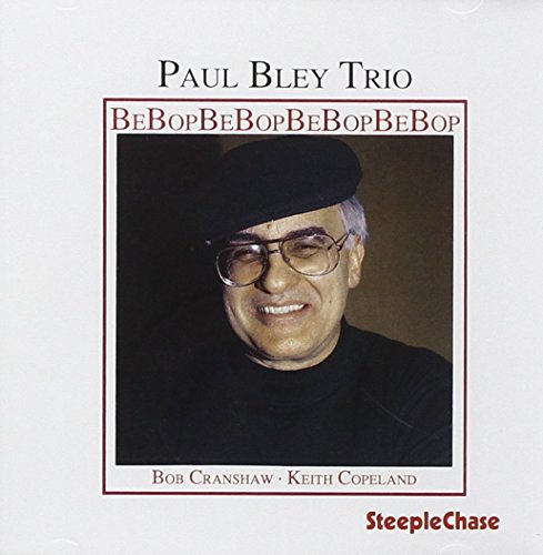 "Album cover featuring a smiling older man wearing glasses and a hat."