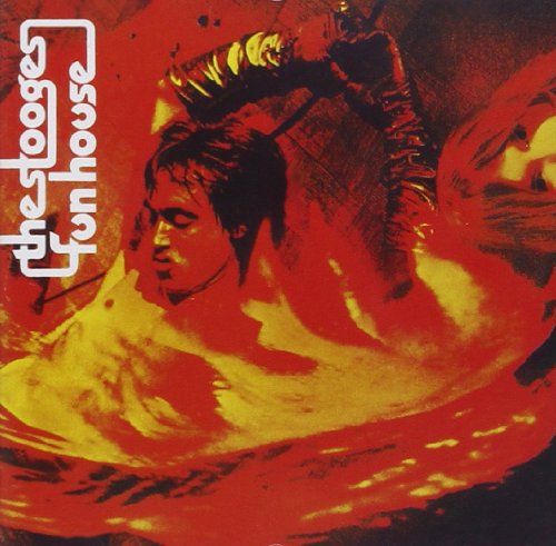 The image is a red and yellow album cover with a man holding a stick.
