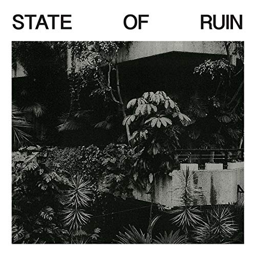 Black and white album cover with overgrown plants and a building.