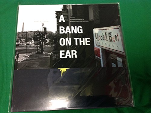 Vinyl record cover with black and white city scene and bold text.